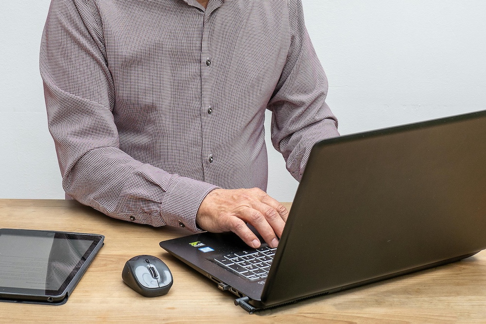 writer typing on a laptop